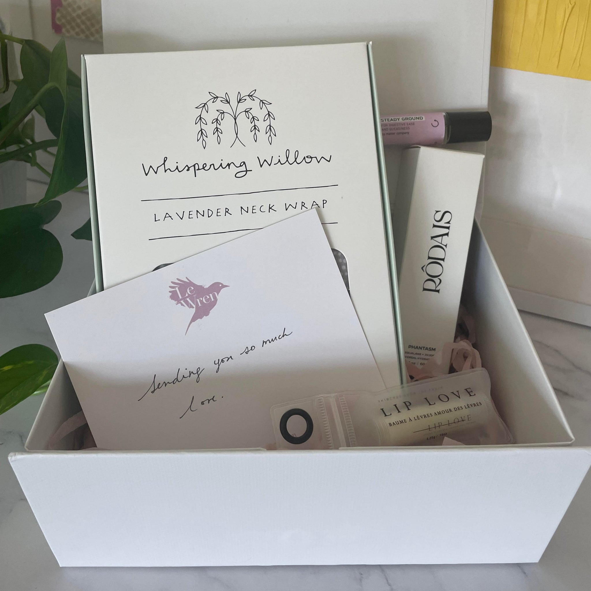 gift box featuring lavender neck wrap, universal organic body oil, anti-nausea roll-on and soothing lip balm