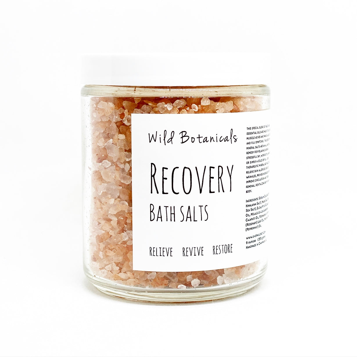 A display photo fo a clear jar of bath salts with a label reading "Wile Botanicals Recover Bath Salts". 