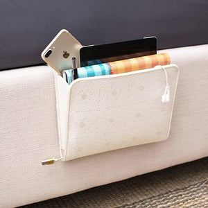 A lightcolored pocket to attach to the side of your bed holds a book, electronics, pen, and phone. Great for beds at home and at the hospital.